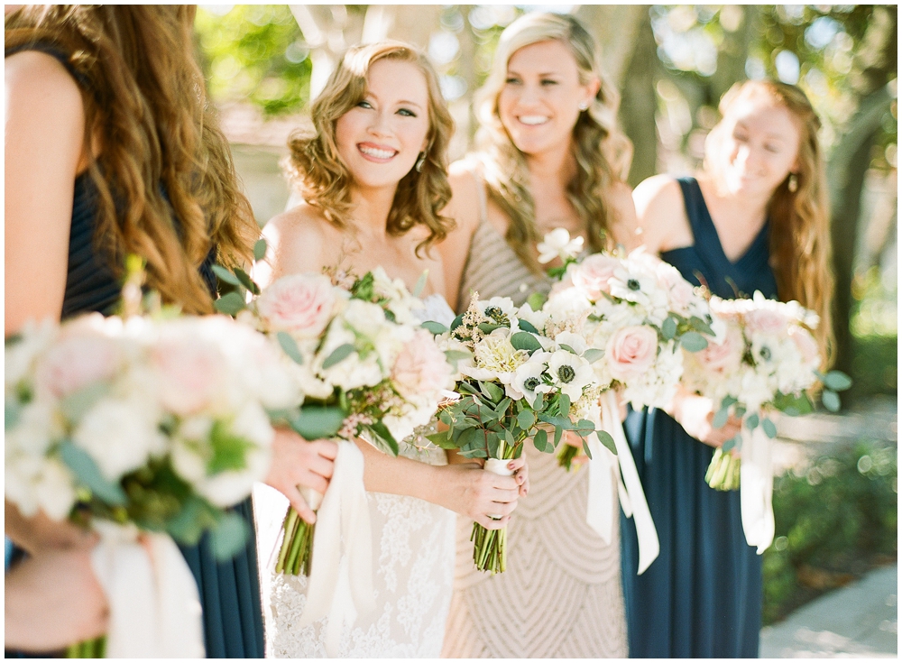 Bridesmaids in gold and navy dresses